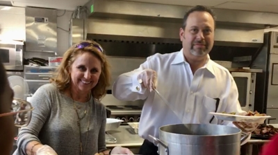 Laurie and Brett serve dinner at West End Boys School Photo